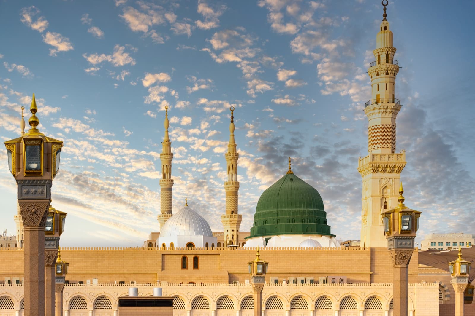 Masjid al-Nabawi with its iconic green dome at sunrise in Madinah